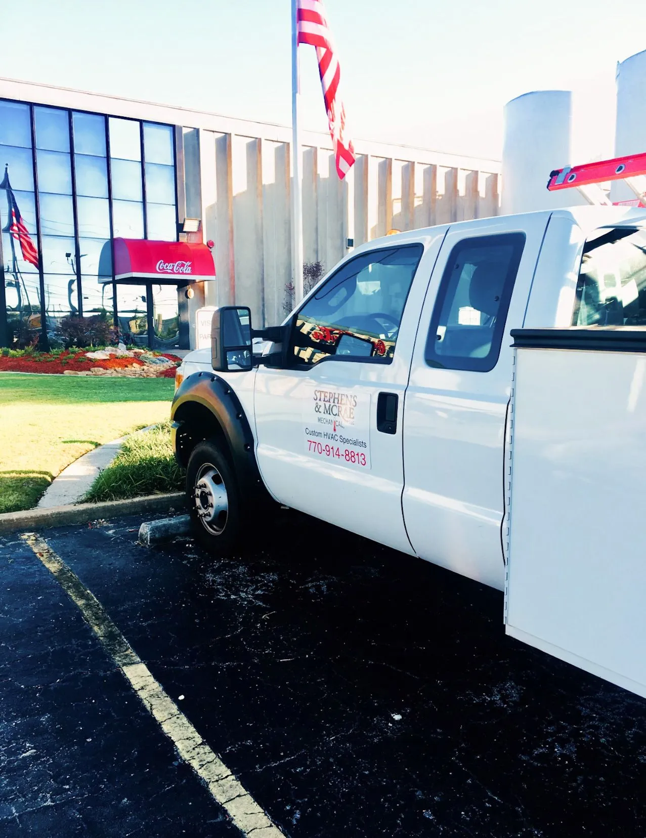 White service truck parked near office building